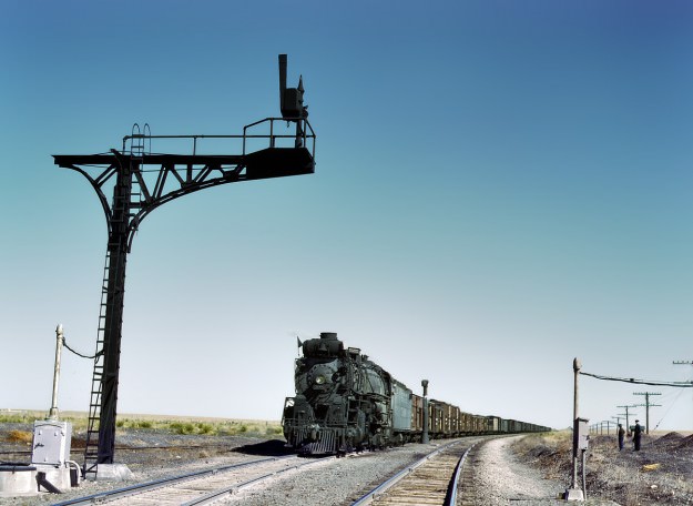 March 1943. Westbound Santa Fe freight on a siding at Ricardo, New Mexico, waiting for the eastbound train to pass. 4×5 Kodachrome transparency by Jack Delano. FSA/Office of War Information archive.
