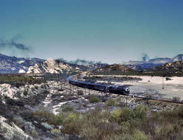 March 1943. Santa Fe trip from Chicago to California. Trains on the Santa Fe tracks through Cajon Pass in the San Bernardino Mountains. 4×5 Kodachrome transparency by Jack Delano for the Office of War Information.