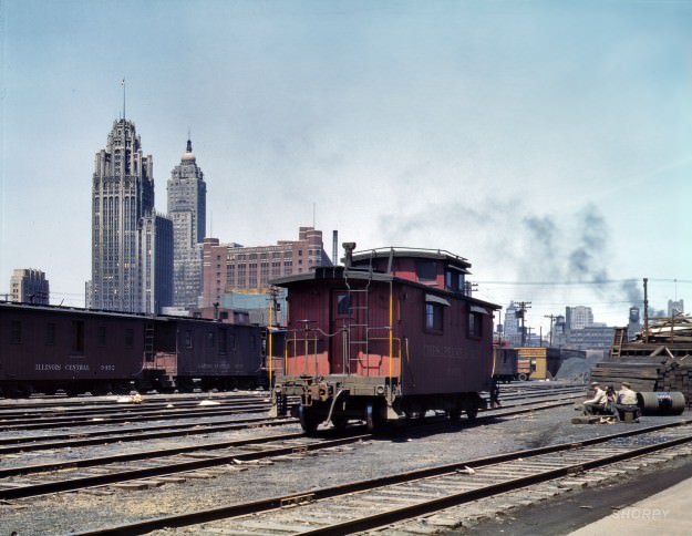 Chicago, April 1943. “General view of part of the South Water street freight depot of the Illinois Central Railroad. Chesapeake & Ohio R.R. caboose.” 4×5 Kodachrome transparency by Jack Delano for the OWI.