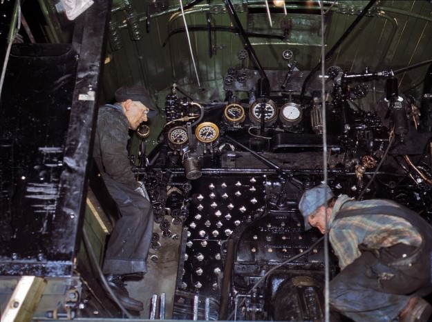 Working on the cab of a locomotive brought in for repairs at the Chicago & North Western 40th Street shops, Chicago. December 1942. 4×5 Kodachrome transparency by Jack Delano.