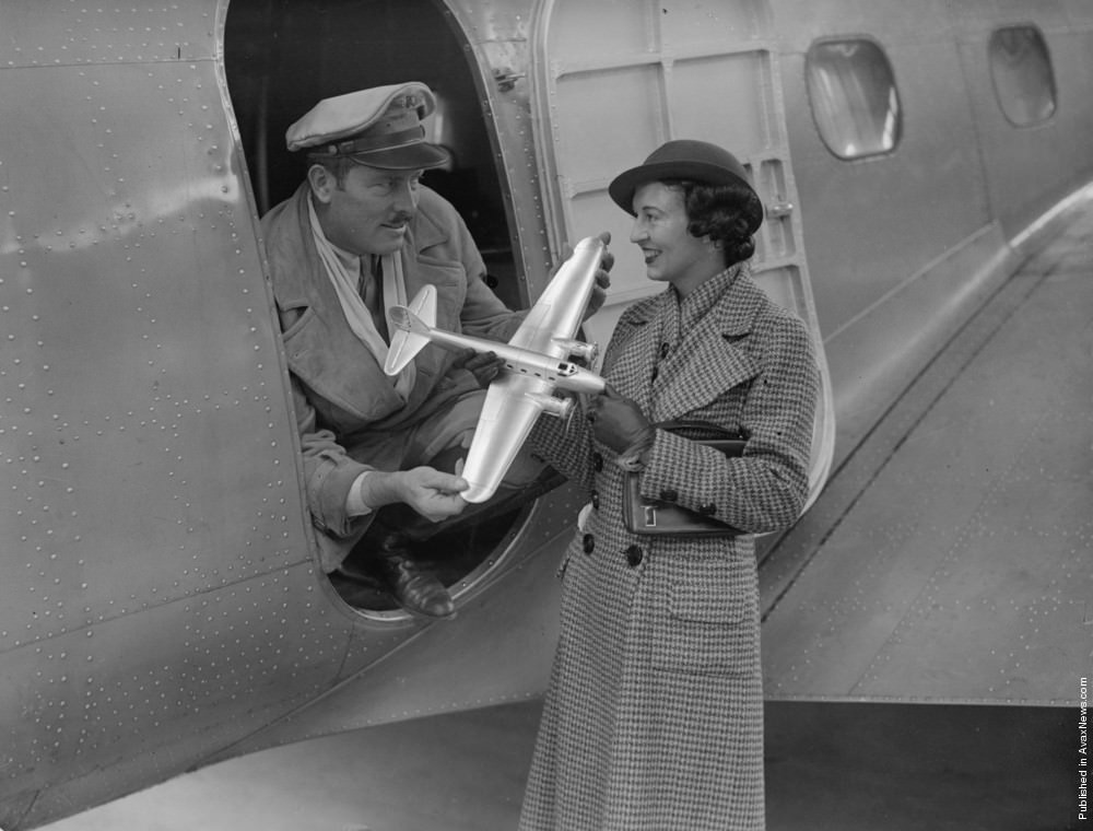 Colonel Roscoe Turner showing his wife a model airplane at Mildenhall airfield, 1934.