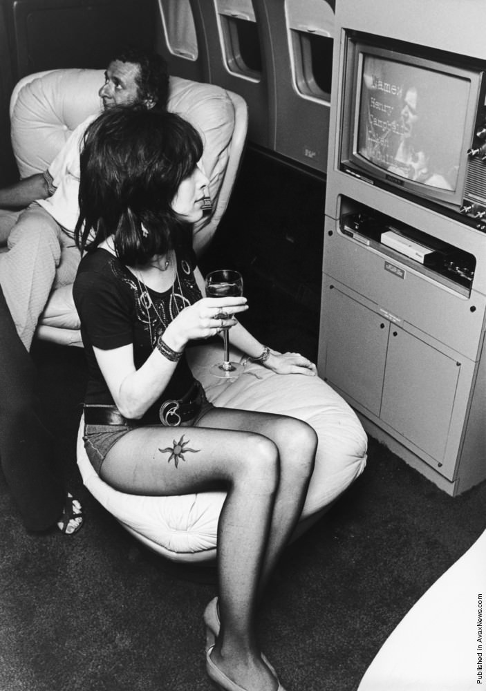 A young woman watching a video on board Led Zeppelin's Boeing 720B "The Starship", 1973.
