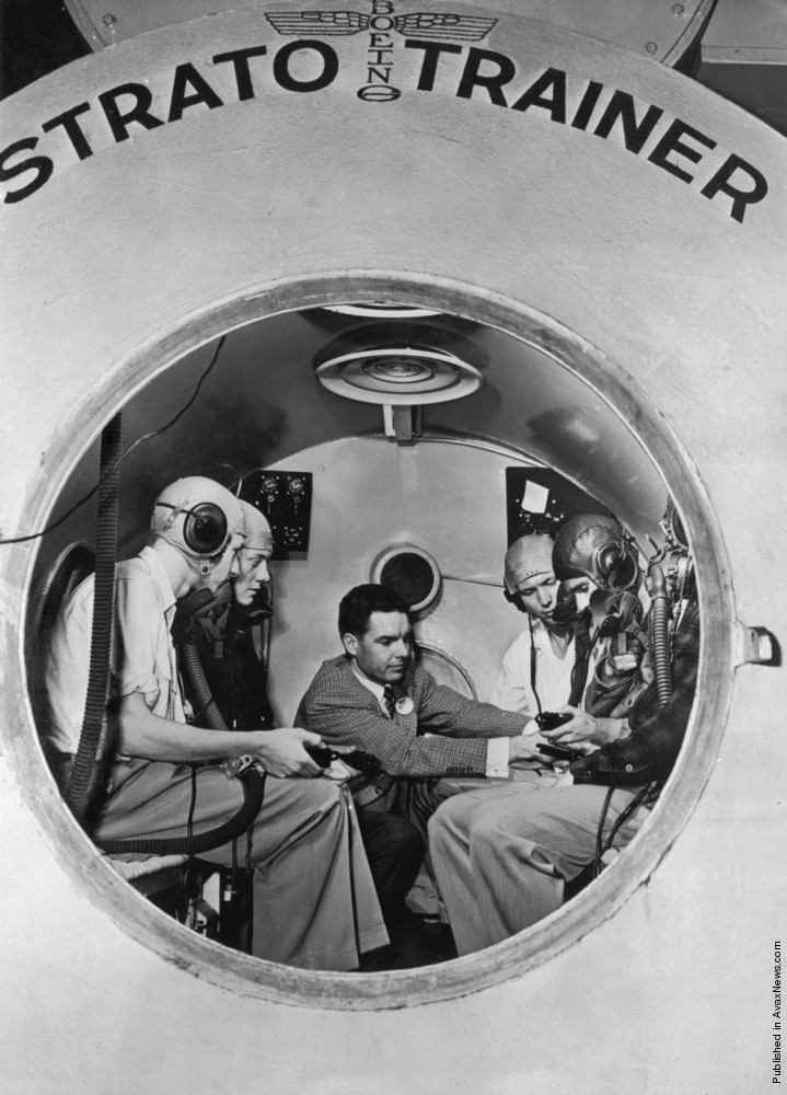 Five mountaineers in a Boeing Strato-Trainer altitude simulator in Seattle, planning an ascent of King peak in Alaska, 1952.