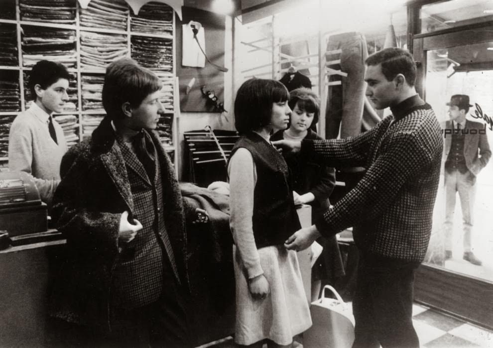 May 1964: A ‘Mod’ girl gets measured for a suit.