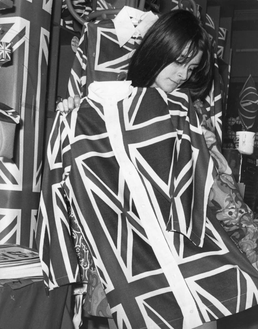 7 January 1968: A boutique owner holds up Union Jack shirts.