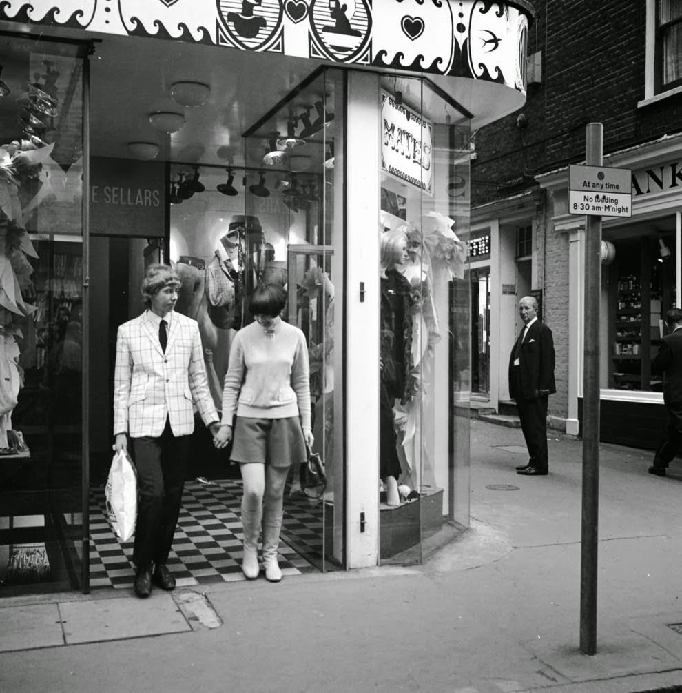 14 October 1966: A young couple coming out of Mates boutique, which sells both men’s and women’s clothing.