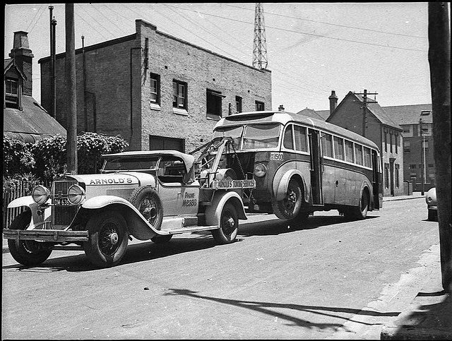 Motor bus being towed to Queensland by a 1929 Cadillac towtruck, Sydney, 1938.