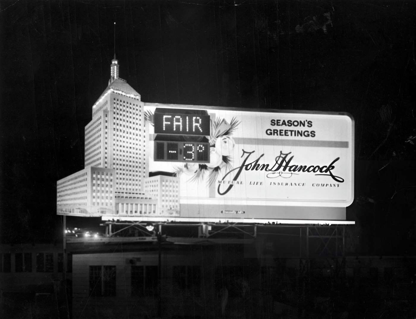 A billboard for John Hancock Mutual Life Insurance Company displays the weather and time in Boston, 1962.