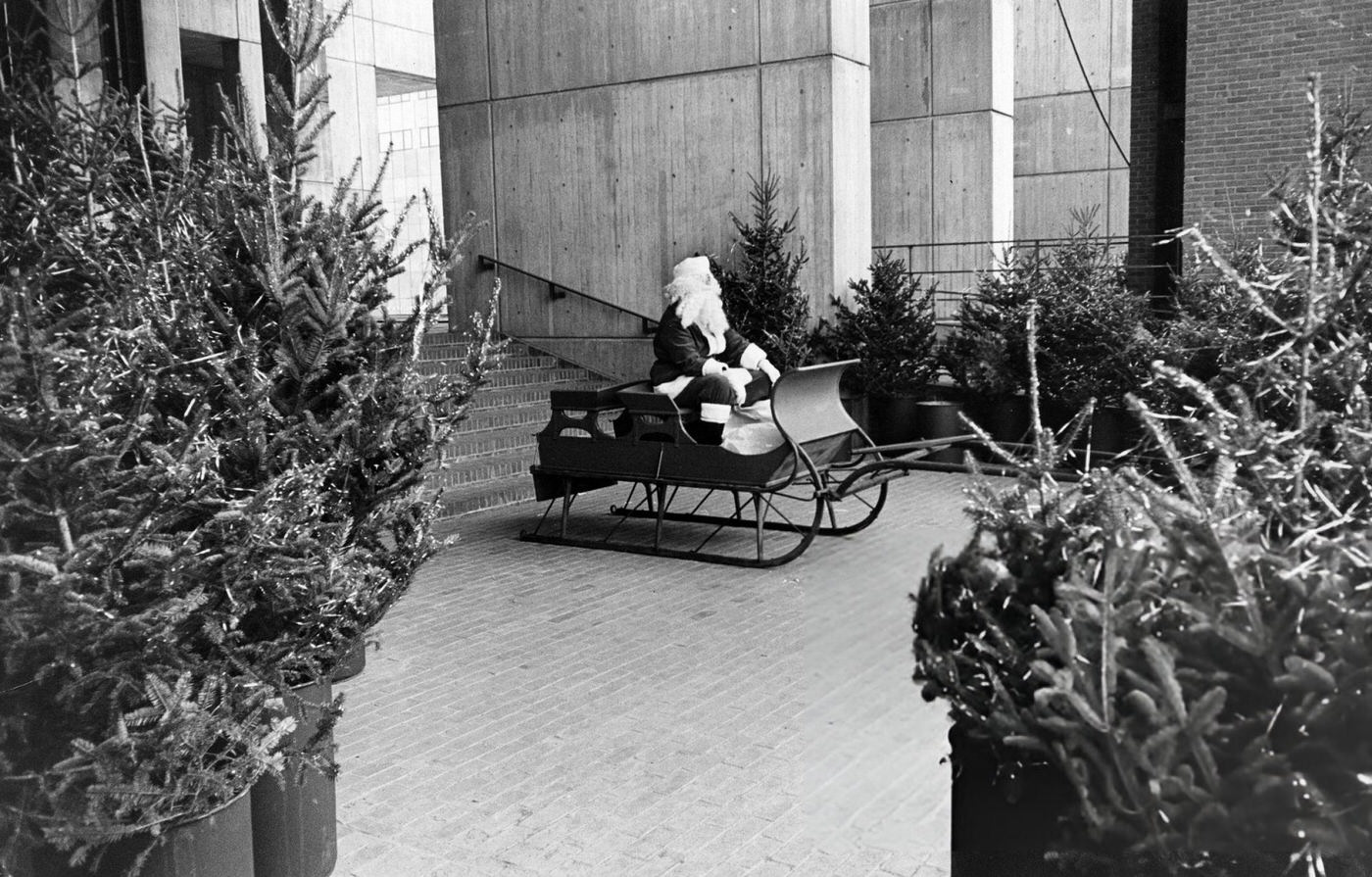 A Santa Claus sits in a sled in City Hall Plaza in Boston, 1969.