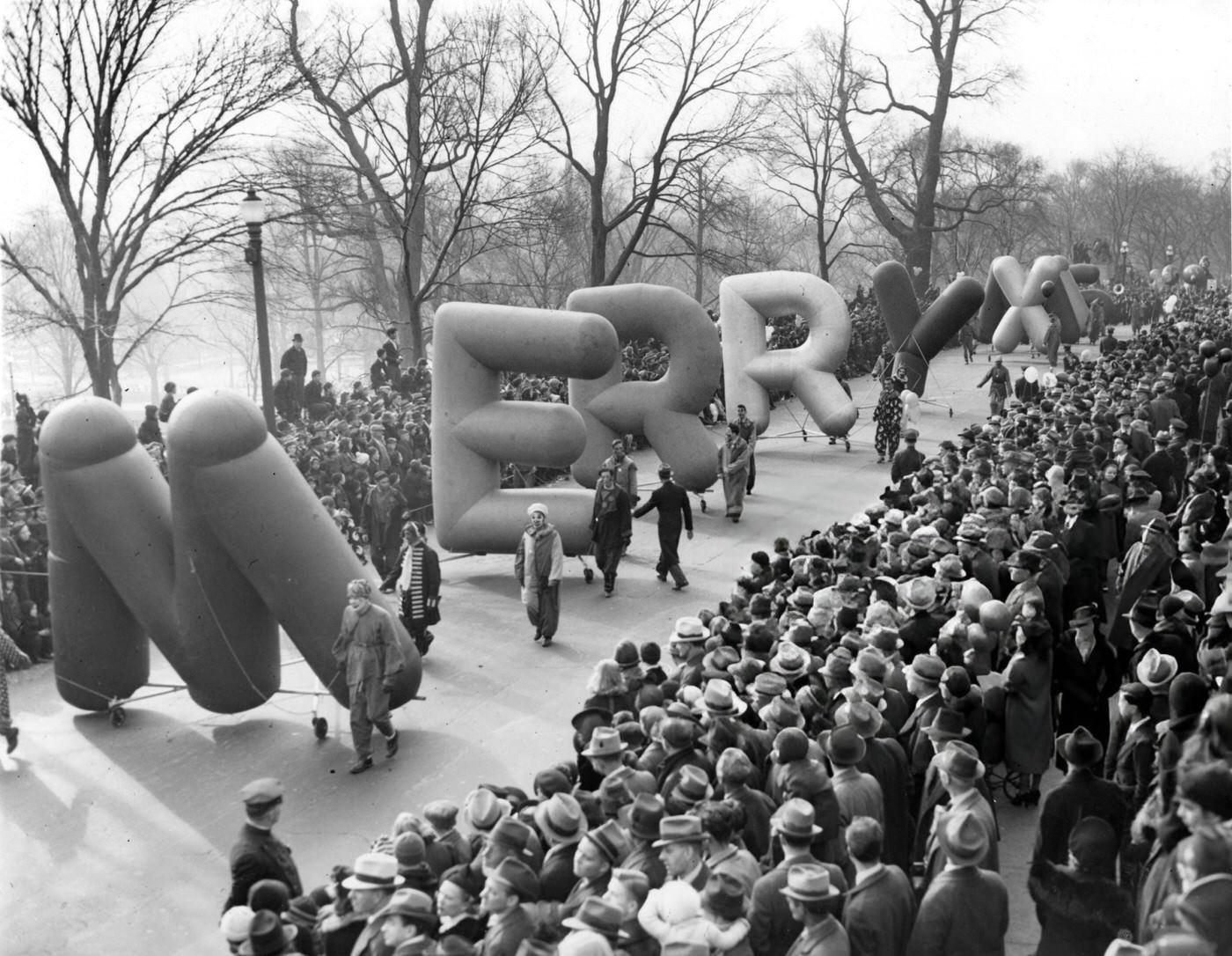 Balloons spelling out "Merry Xmas" carried during the annual Santason parade in Boston, 1939.