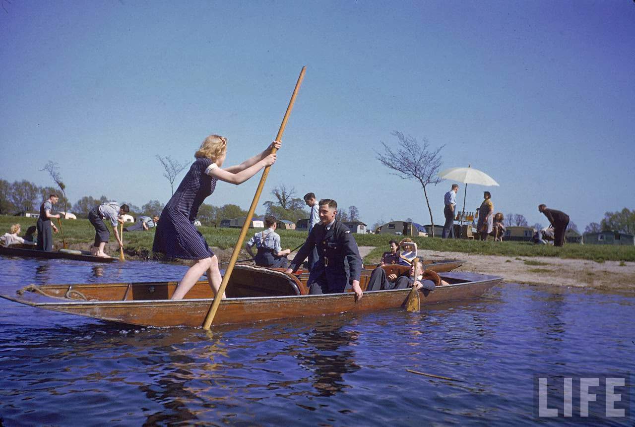 Woman pilot taking pair of soldiers punting on the River Avon.