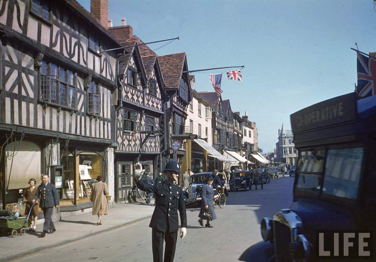 Policeman directing traffic during birthday celebrations honoring William Shakespeare.