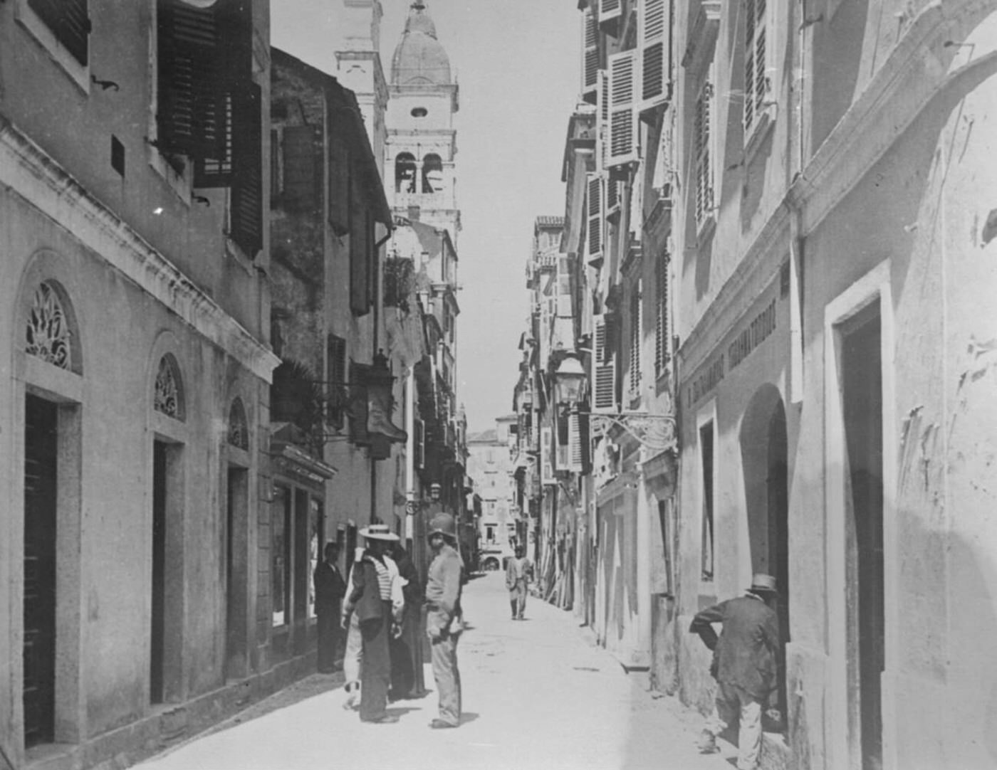 A typical street in Corfu, the Calle S Spiridione, with a figure bearing a resemblance to a London policeman, 1923.