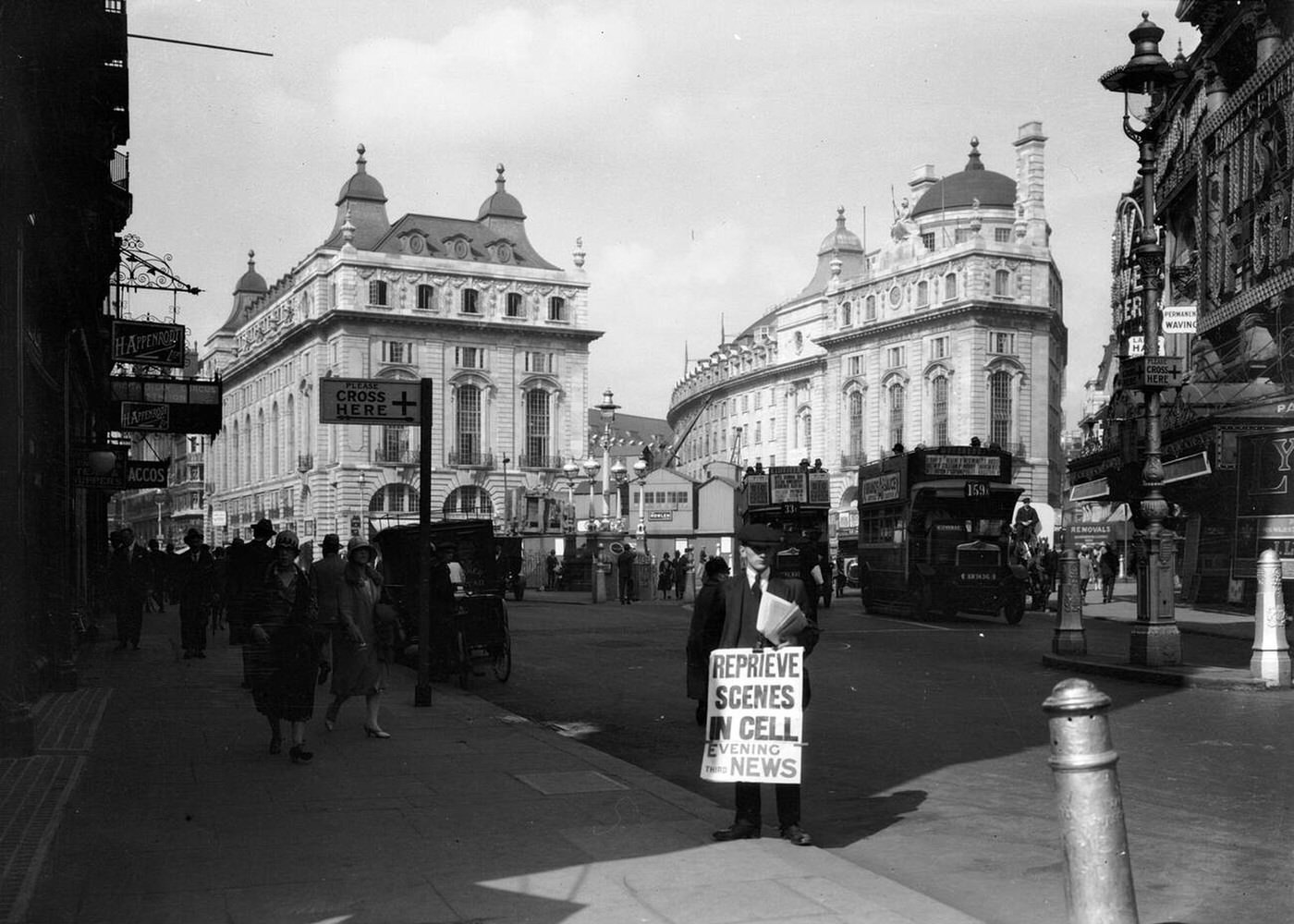 A street scene in Piccadilly Circus, London, with a newspaper hawker advertising a headline from *The Evening News*, 1921.