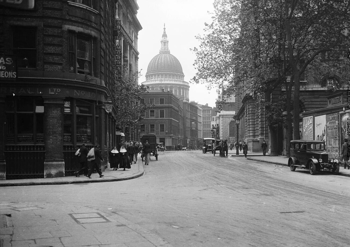 A street scene with St Paul's Cathedral in the background, London, with needle manufacturer Abel Morrall on the corner, 1921.
