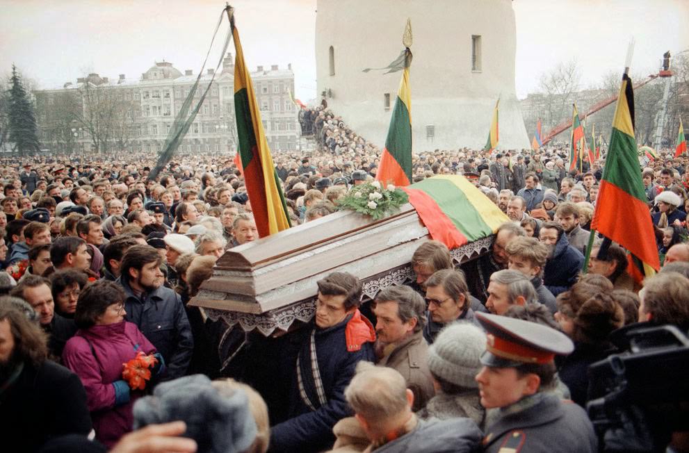 Pall-bearers carry a flag-draped casket during a funeral procession in Vilnius, 1991.