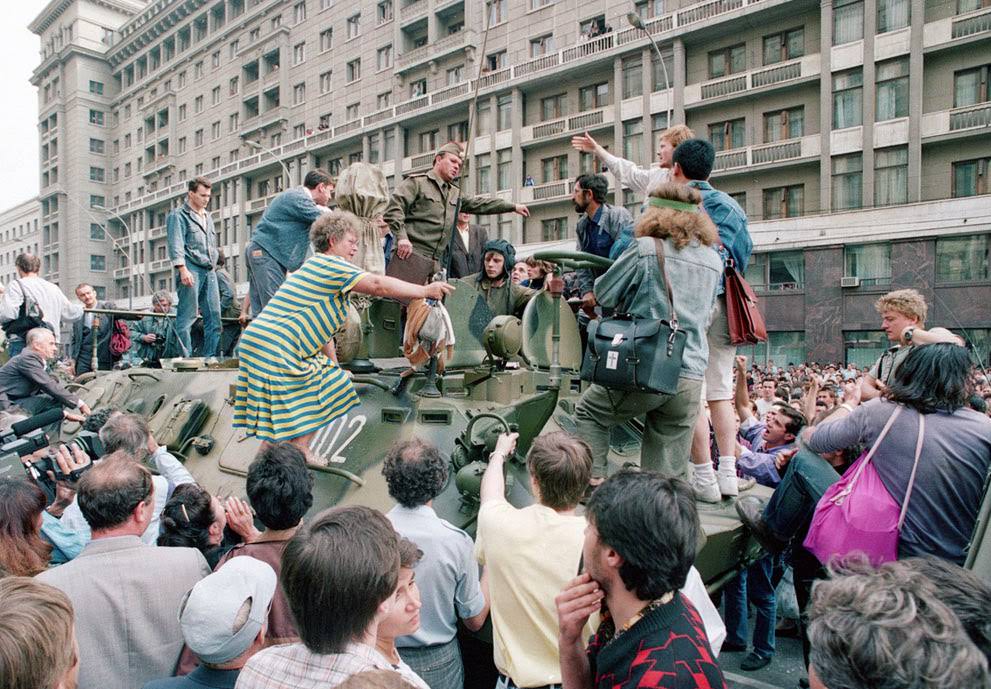 A crowd gathers around a personnel carrier near Red Square in Moscow during a coup attempt, 1991.