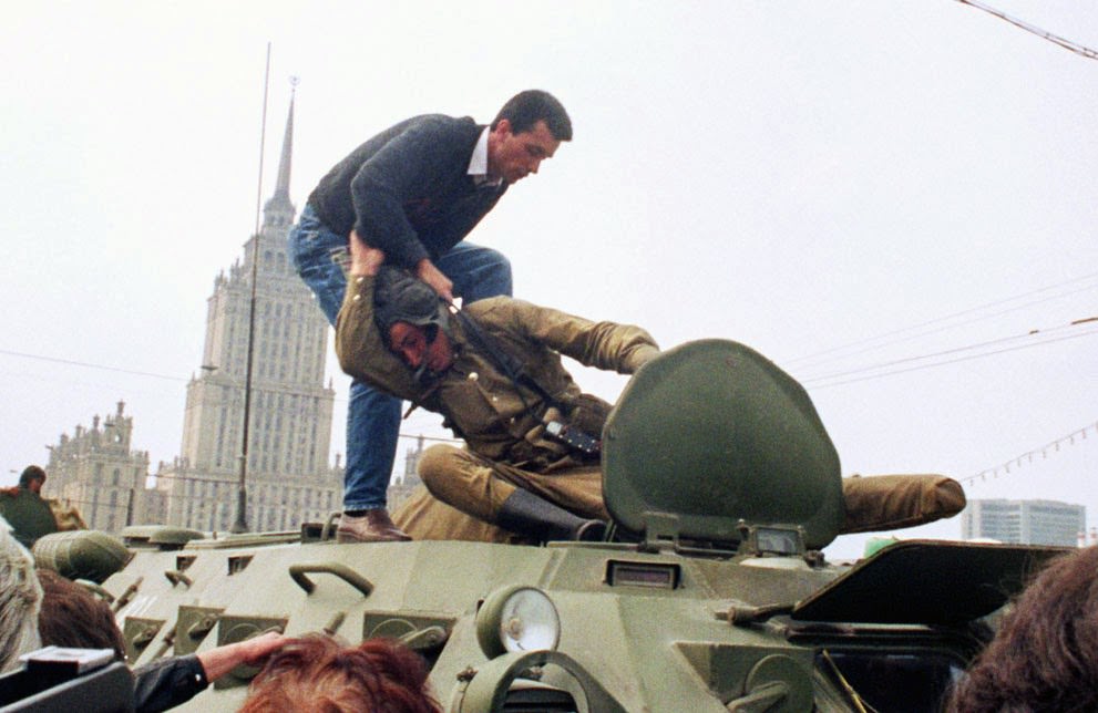A pro-democracy demonstrator fights with a Soviet soldier on a tank in Moscow, 1991.