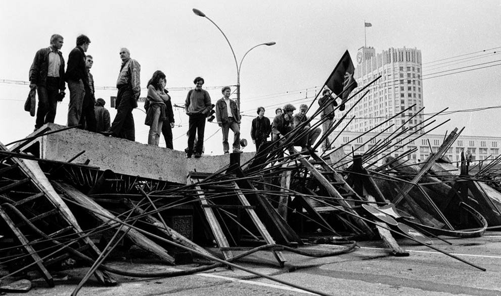 People stand on a barricade in front of the Russian White House in Moscow, 1991.