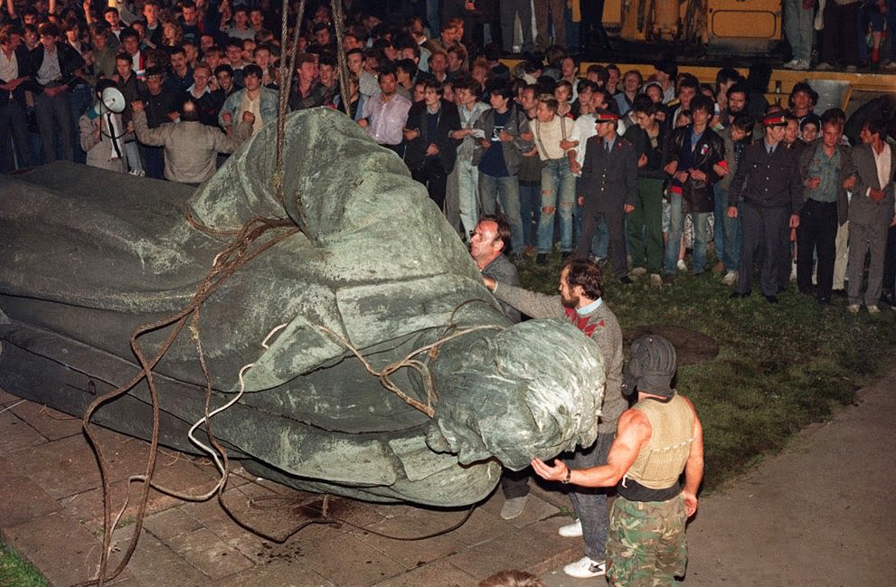 A crowd watches the statue of KGB founder Dzerzhinsky being toppled in Lubyanskaya Square in Moscow, 1991.