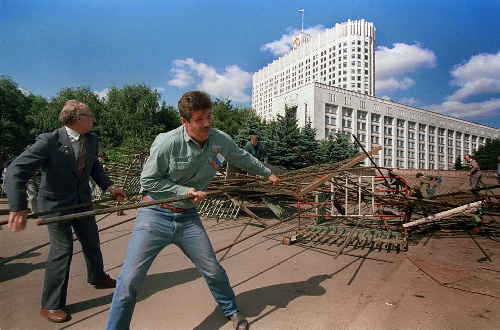 Boris Yeltsin supporters rip apart barricades surrounding the Russian federation building in Moscow, 1991.