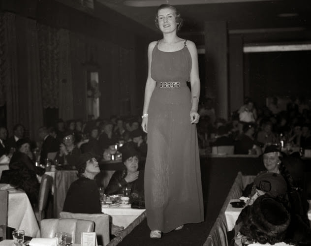 The catwalk hasn't changed much in over 75 years. Here, a model walks the runway at a 1935 society fashion show.