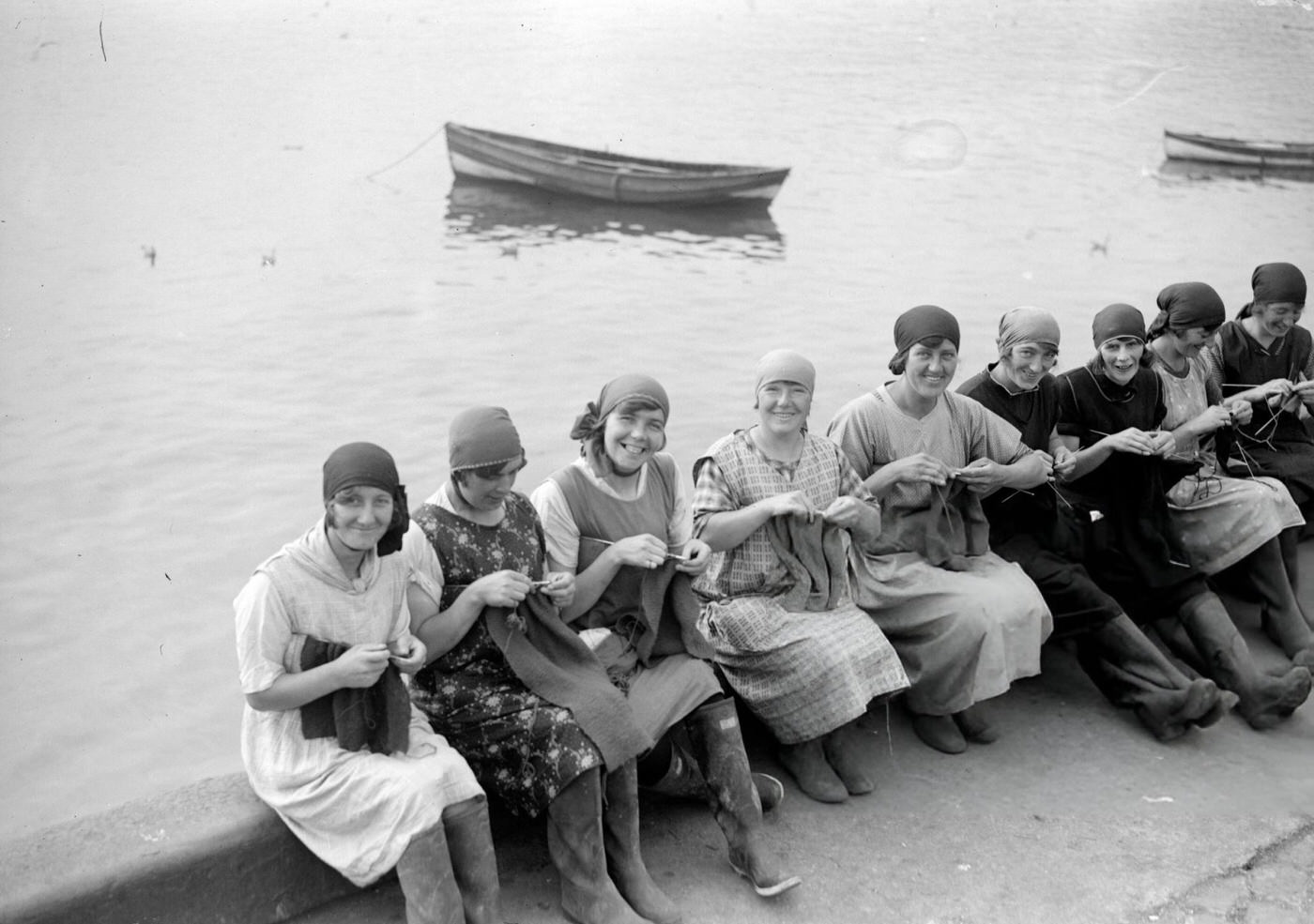 Yarmouth fisher-girls knitting as they wait for the fishing boats to come in, 1929.