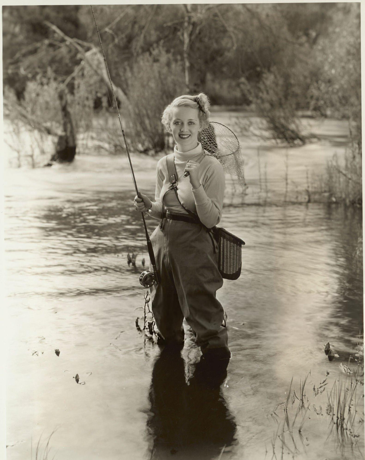 Bette Davis on a fishing expedition in the California mountains.