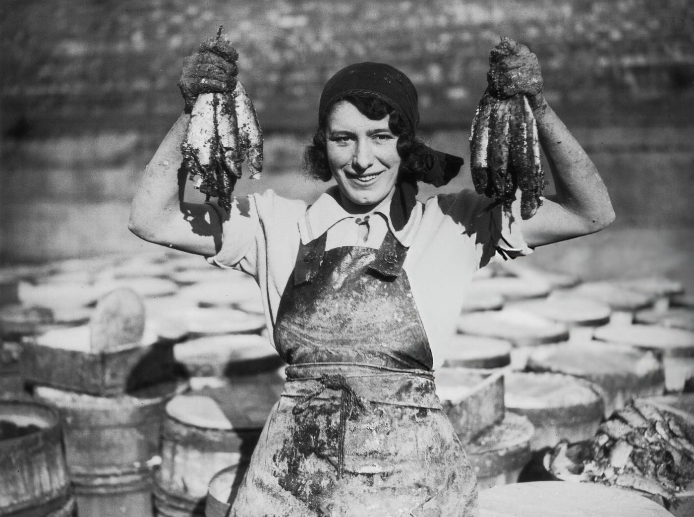 A young woman at Great Yarmouth working during the herring harvest, 1932.