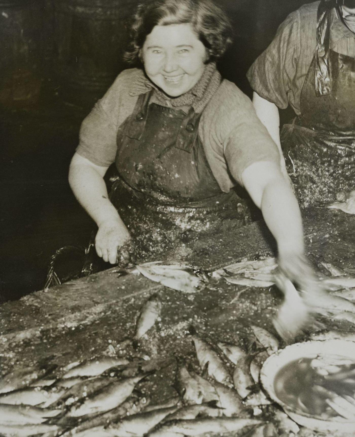 Scottish fisherwomen cleaning herring at Yarmouth, England, 1936.