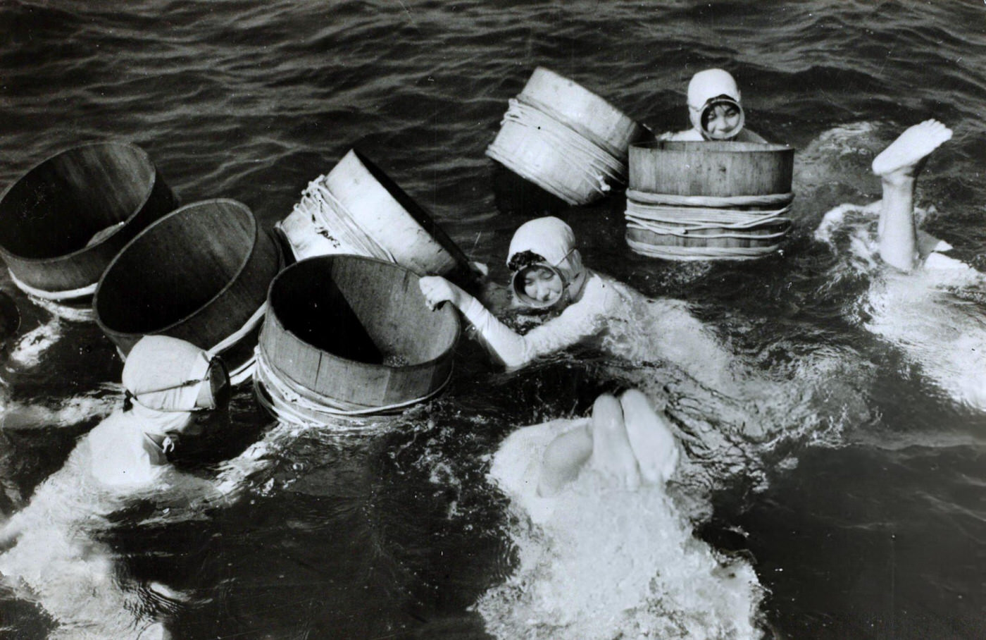 Japanese girl divers collecting oysters from the sea and river estuaries, 1959.