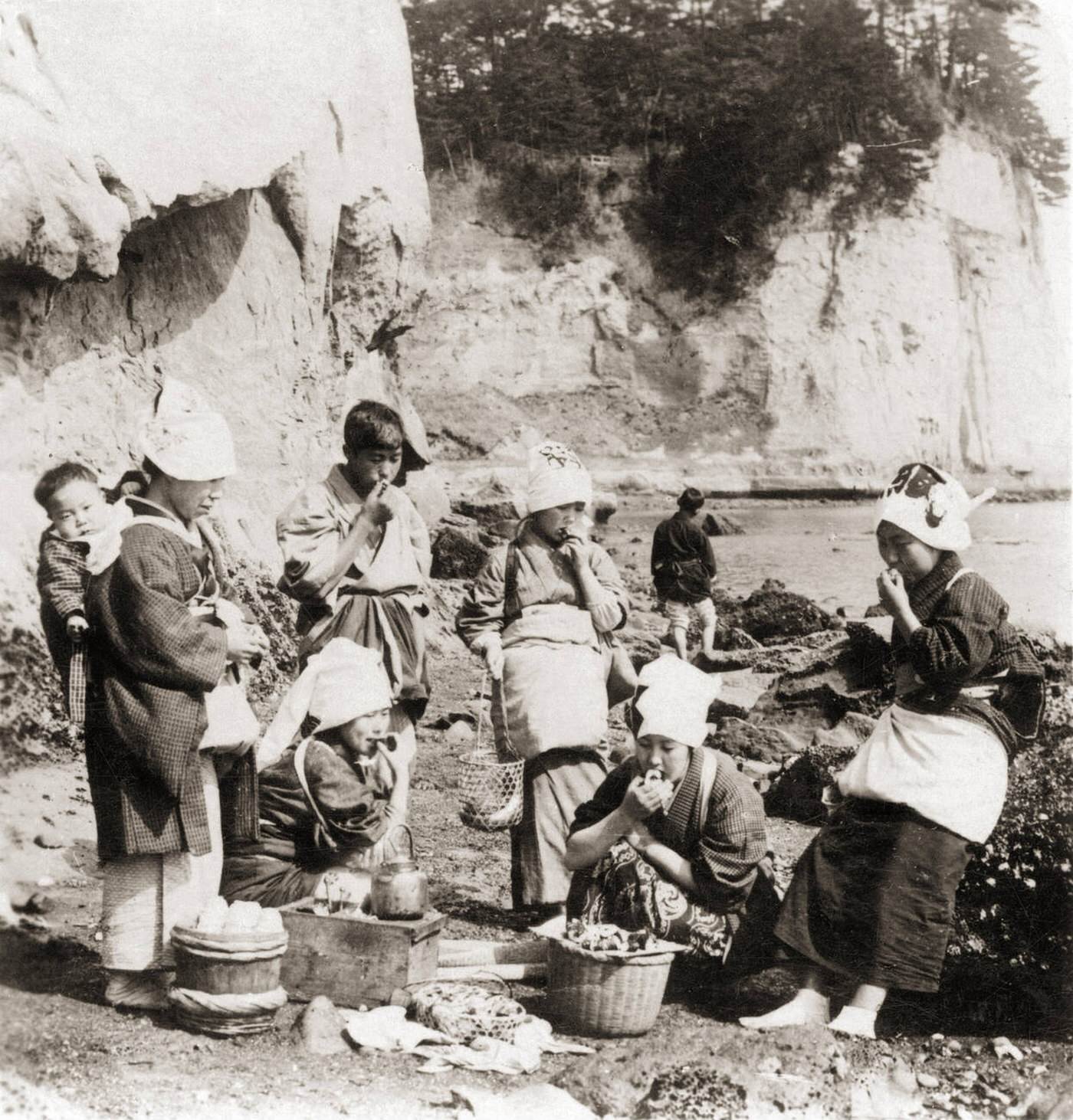 Japanese fisherwomen having a lunch break, 1900s.