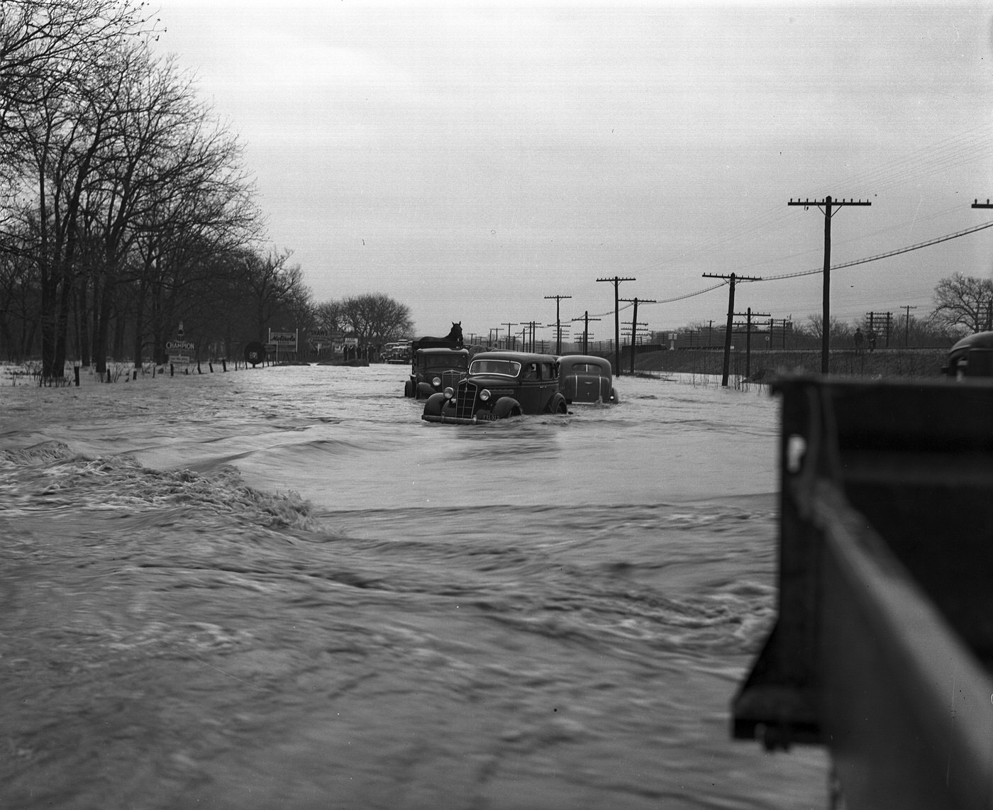 Cars driving through floodwater on Dallas Pike, Fort Worth, 1938