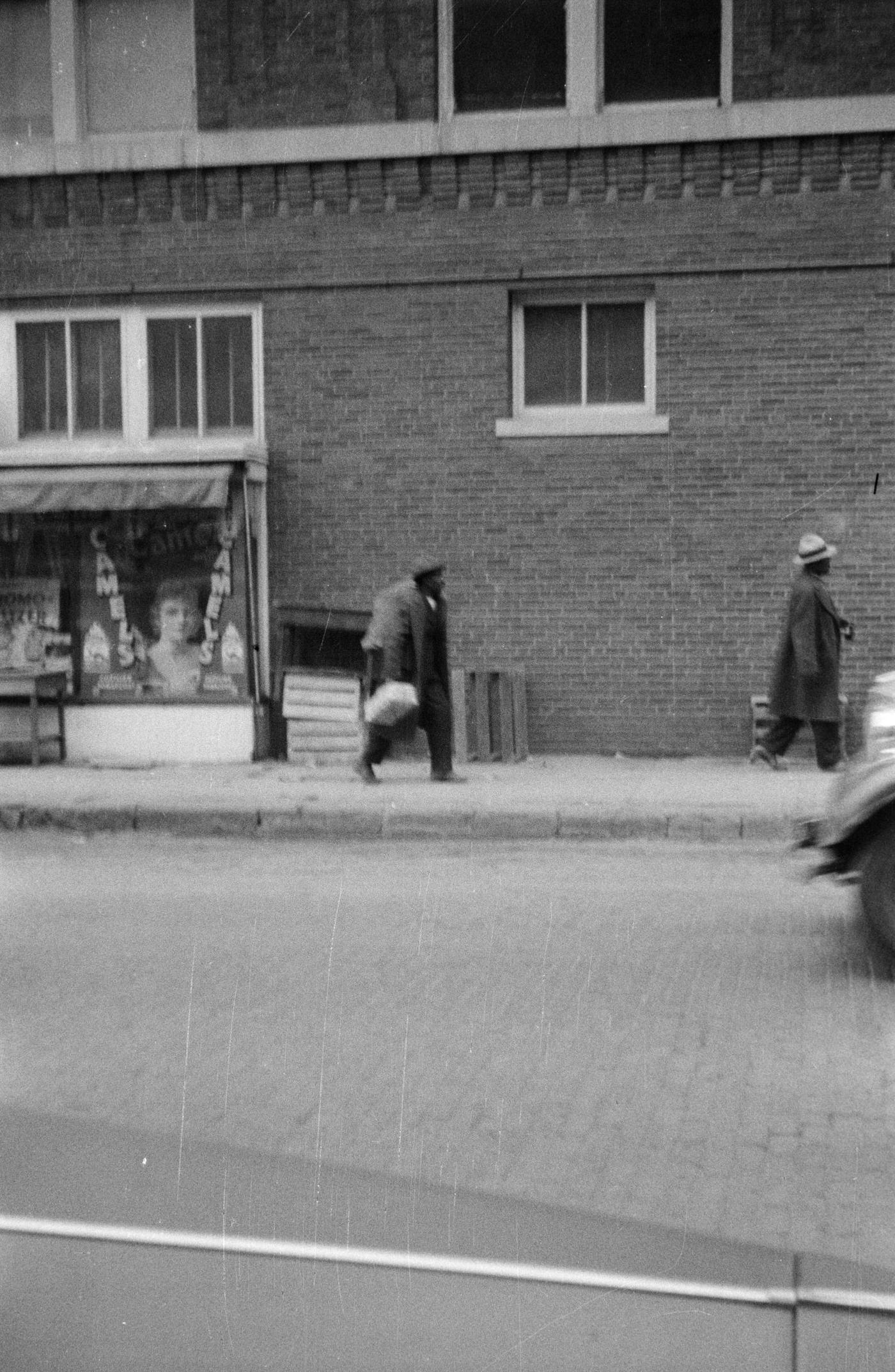 Two men walking on a brick street in downtown Fort Worth, Texas, 1930.