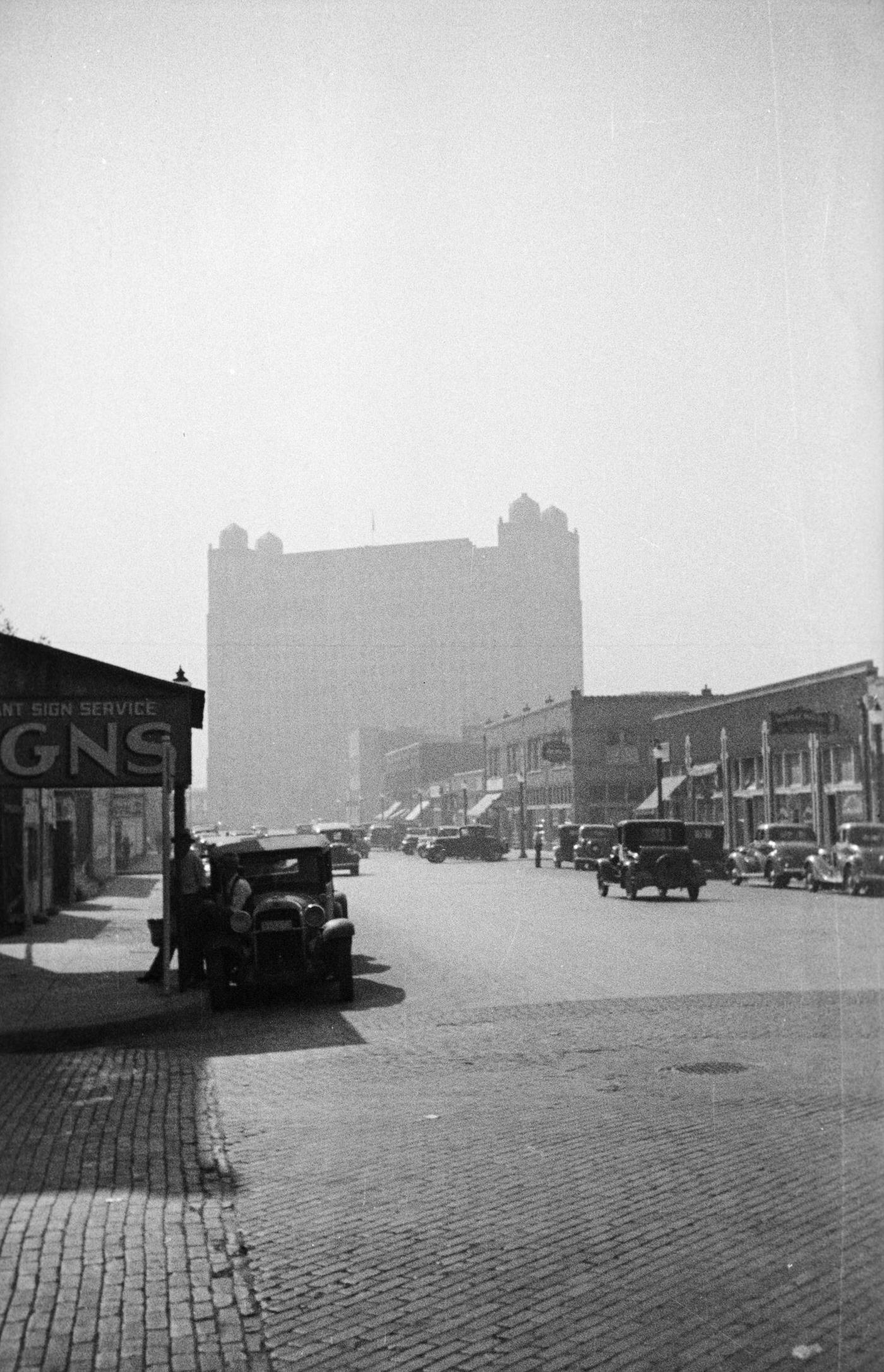 A busy street lined with businesses in Fort Worth, Texas, 1930s.