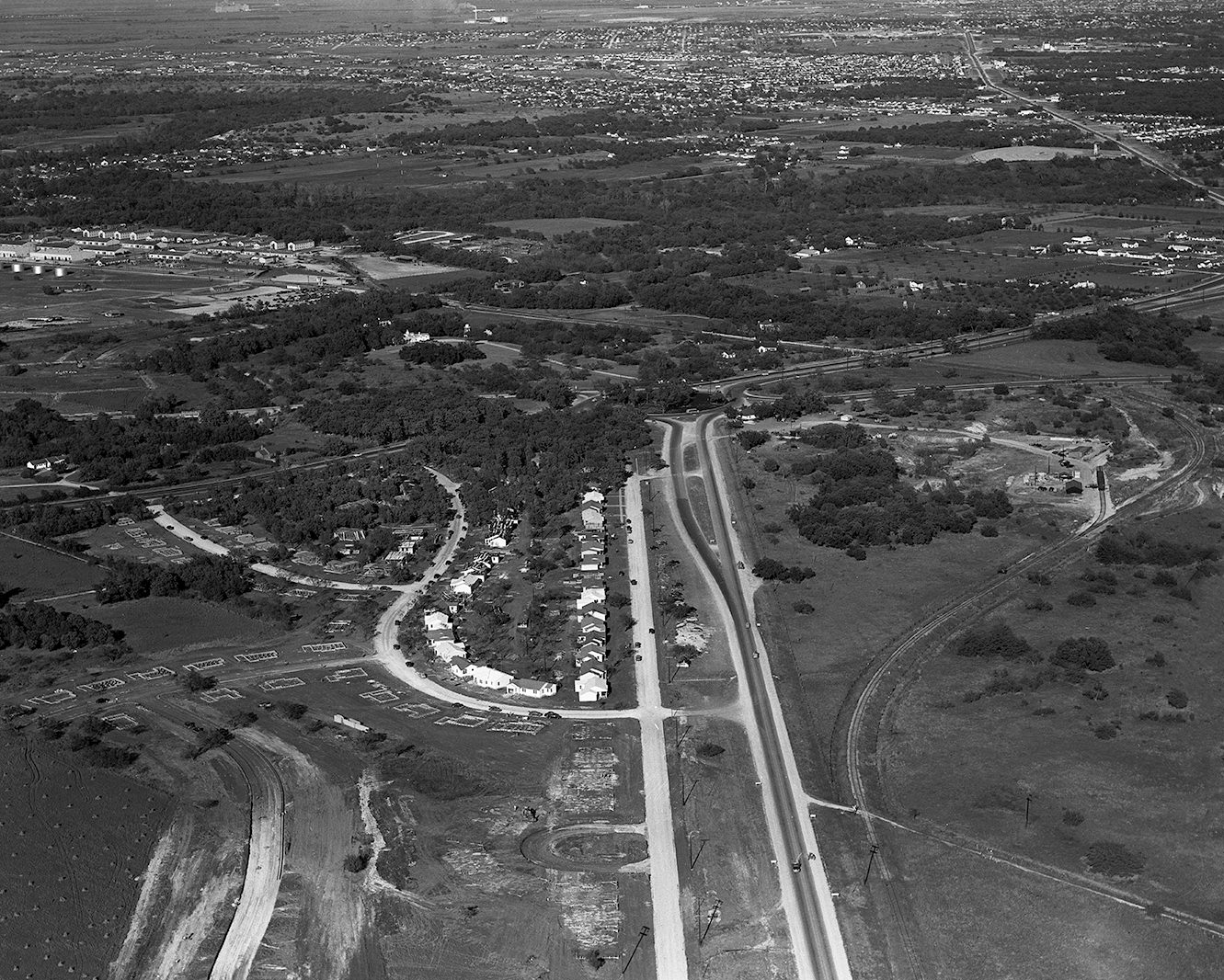 Aerial picture shows progress in building 600 living units for military personnel near Carswell Air Force Base, 1950.