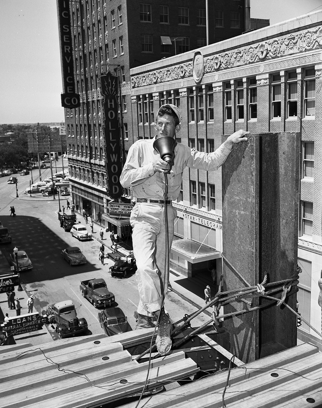 R. E. Higlin on top of Jesse Jones office building under construction, 1951.