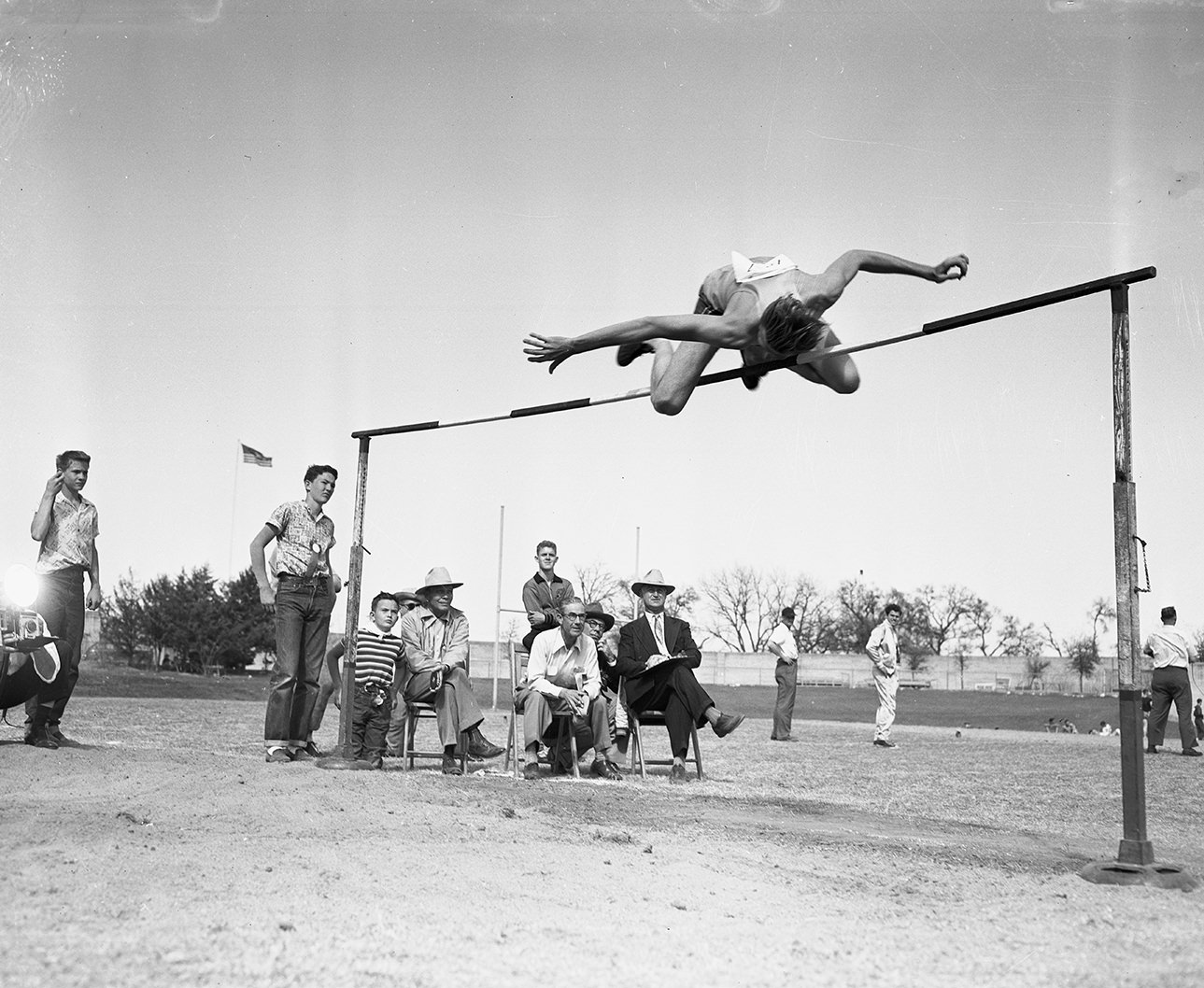 Charley Holding, East Texas high jumper, clears the bar at Southwestern Recreation record, 1951.