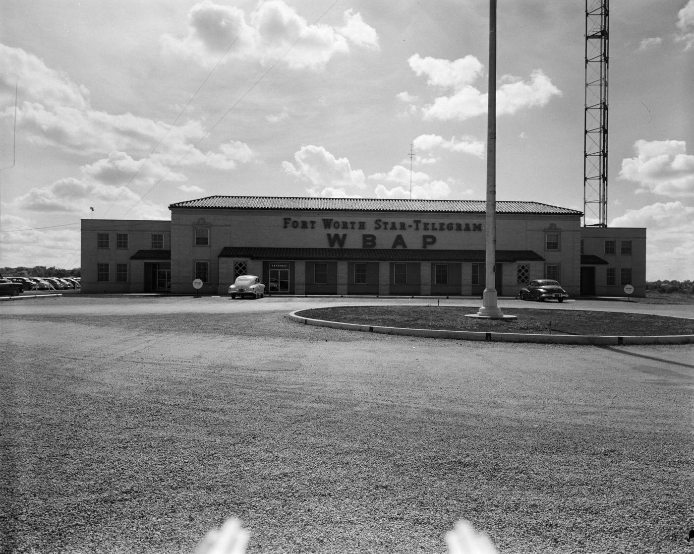 The Fort Worth Star-Telegram WBAP building with parked cars, 1950.