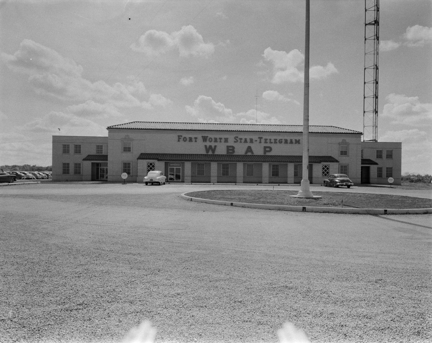 The Fort Worth Star-Telegram WBAP building with parked cars, 1950.