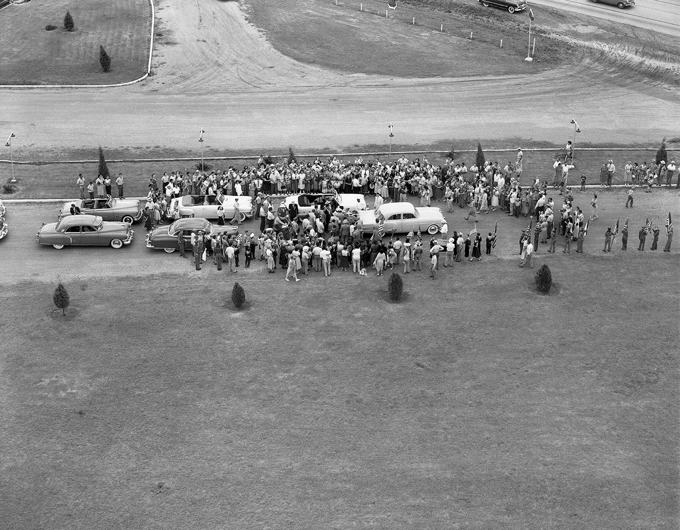 Crowd gathered at the Pike Drive-in Theater cheered as General Douglas MacArthur got into a waiting convertible for the parade, 1951.