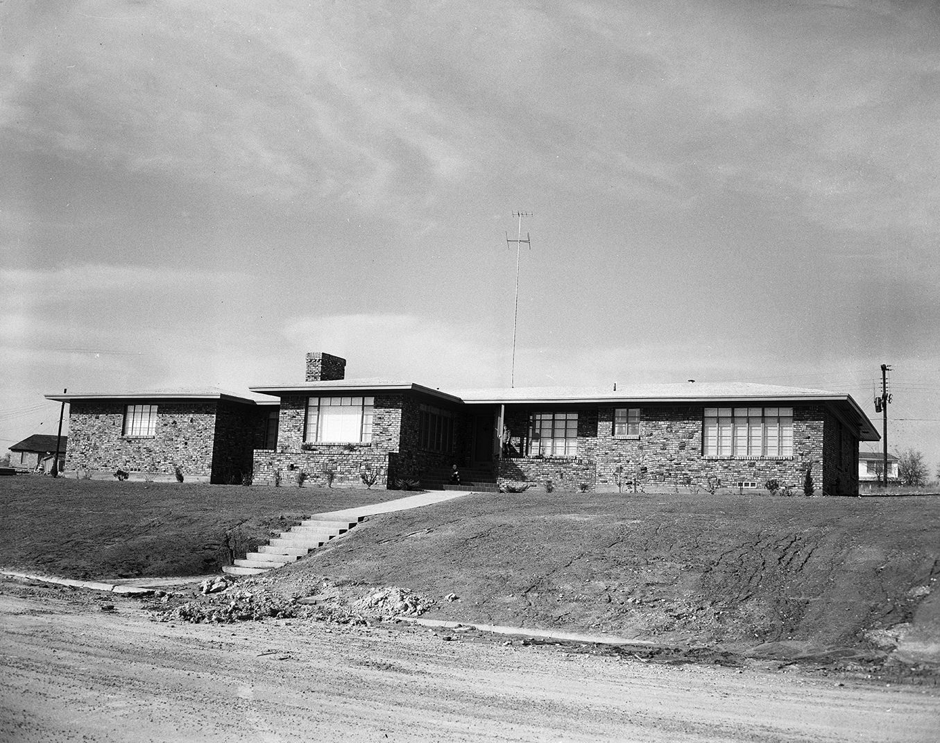 The home of Thomas G. Rumph Jr., at 3680 Encanto Drive, with clinker brick walls and a crushed marble roof, 1951.