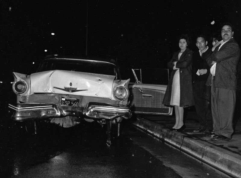 A 1957 Ford Fairlane involved in an evening accident at Hazelwood and Ventura, Fresno, March 22, 1964