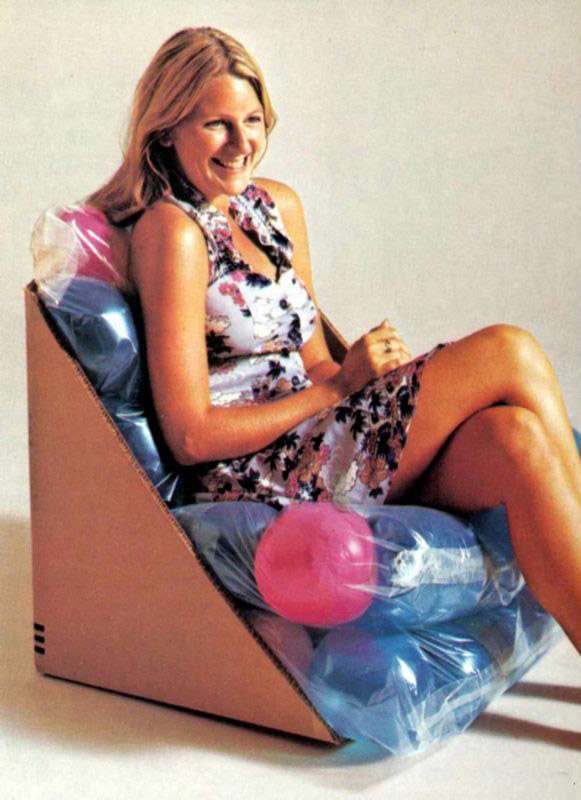 A cardboard box with rubber balls wrapped in plastic.