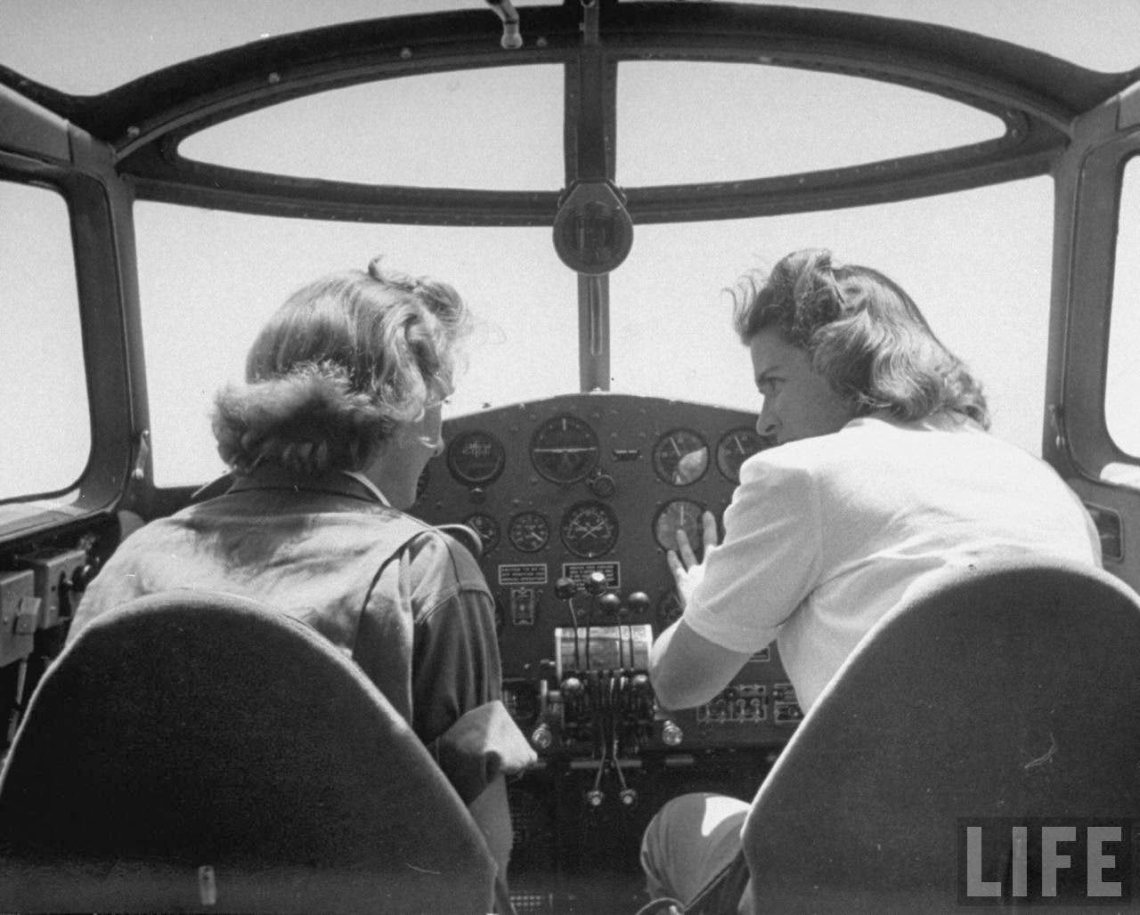 Flying instructor Helen Duffy (R) going over cockpit procedure w. one of her advance pilot trainees in the Women's Flying Training Detachment, as she trains them to qualify for the all-civilian Women's Auxilary Ferrying Squadron, at Avenger Field.