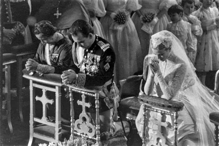 Grace Kelly and Prince Rainier kneel during Mass at their religious wedding, April 1956