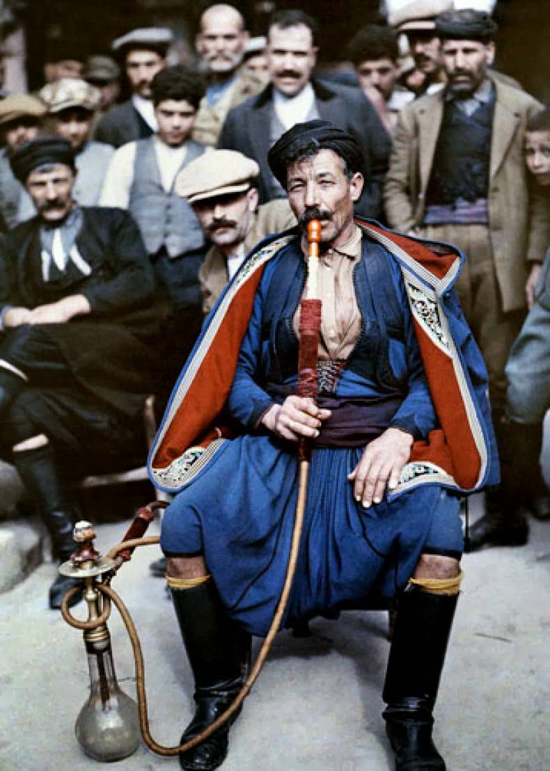 A man in national costume smokes a waterpipe, Crete.