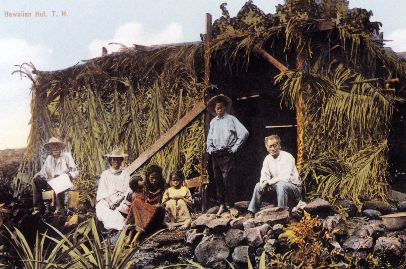 Family in front of their hut, Hawaii, 1904.