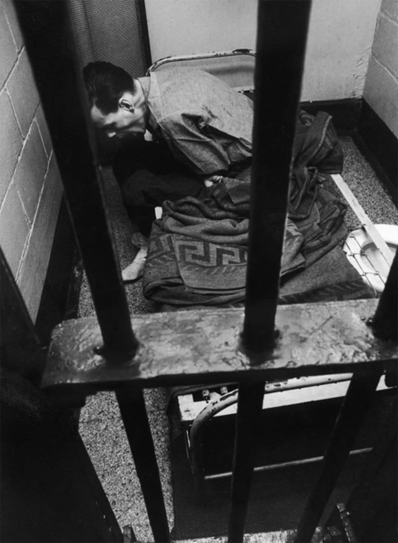 John in jail for disorderly conduct, suffering withdrawal pains in his cell.