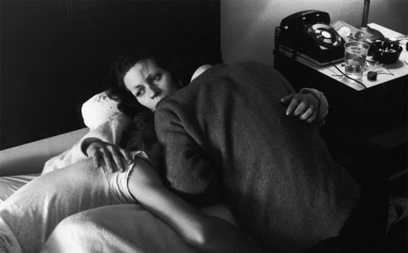 Karen with her arms around boyfriend Johnny and his brother, Bro, who is also an addict, as they lie hopelessly on a hotel bed.